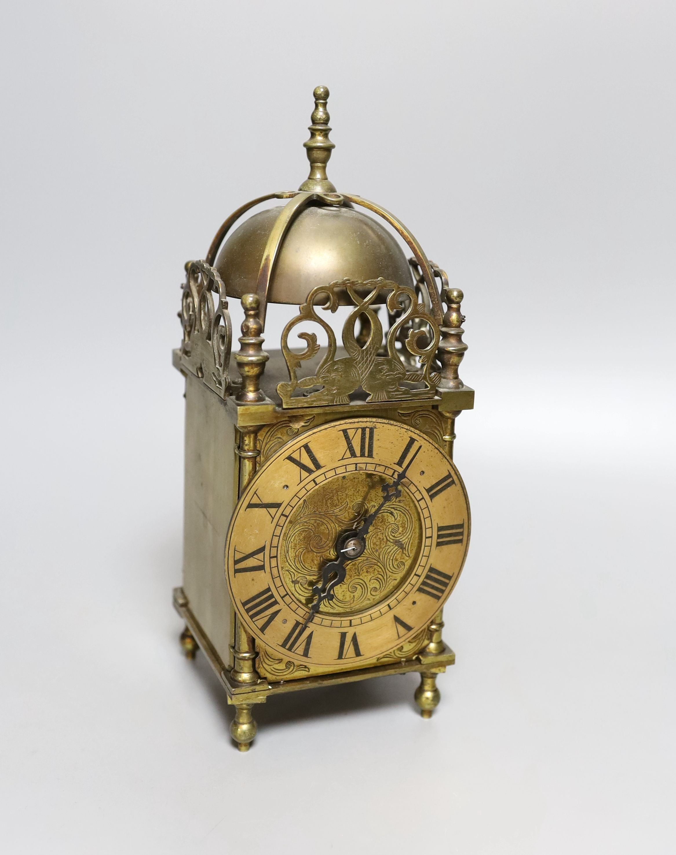 A 19th century miniature brass lantern clock, with key. 24cm